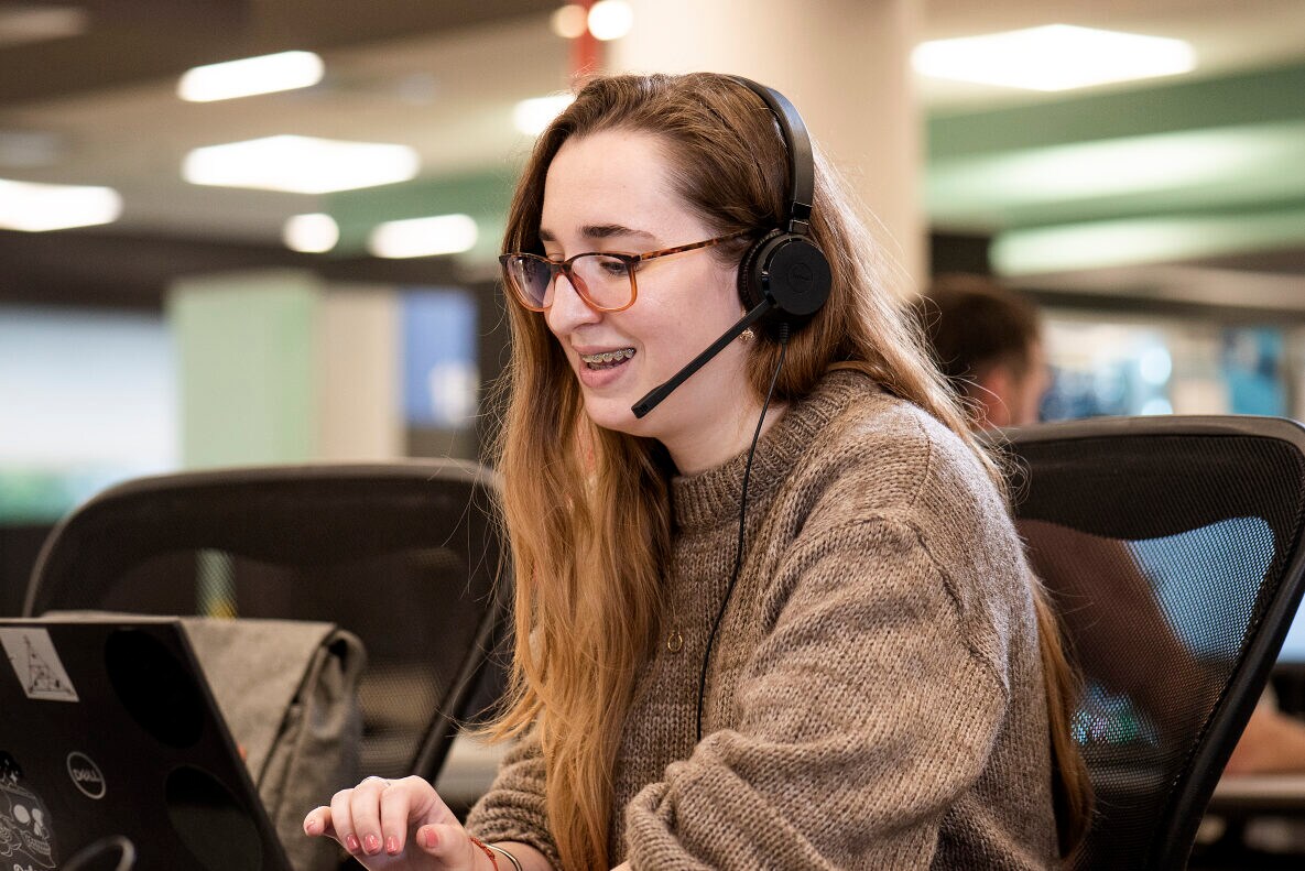 Woman using laptop and headset