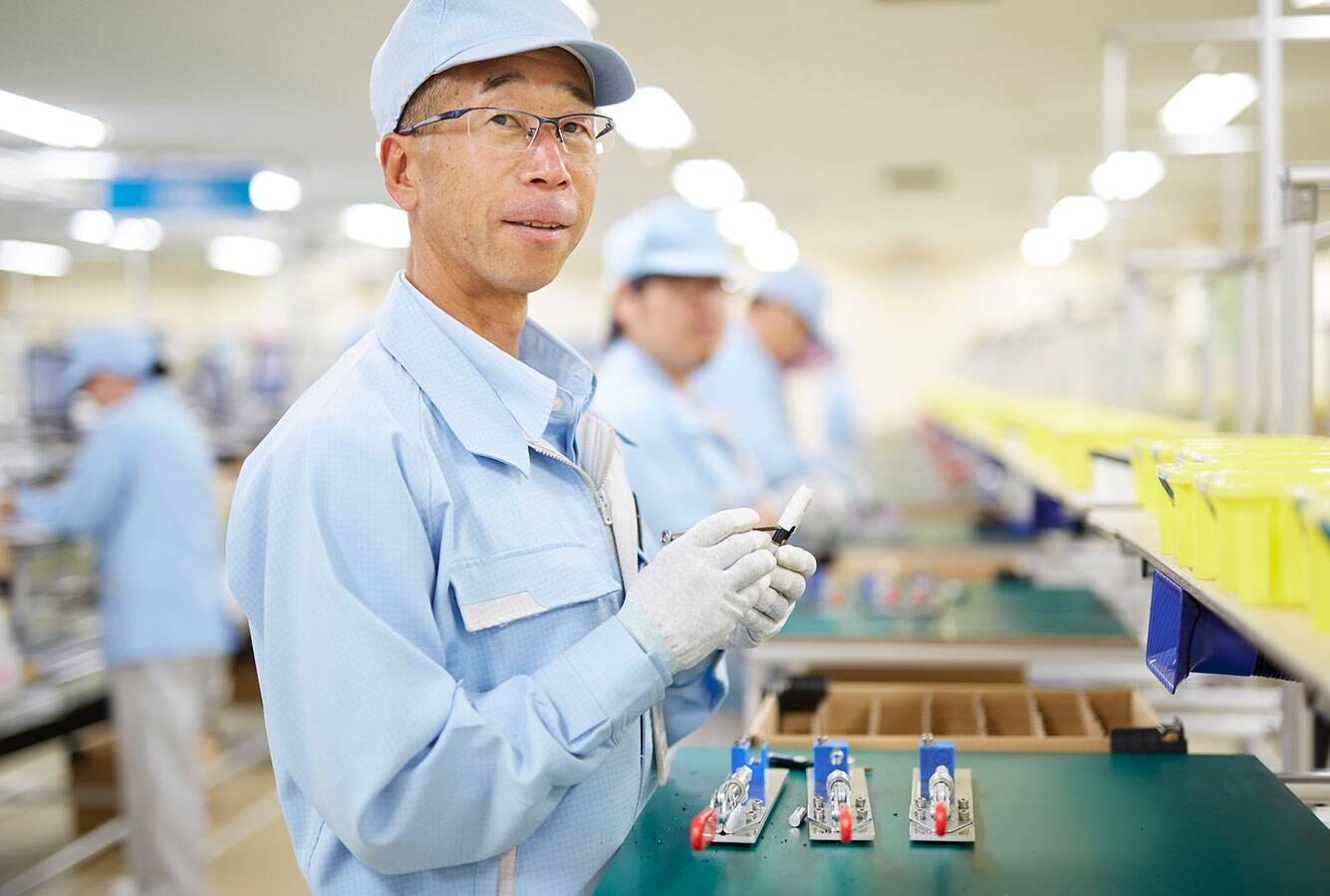 Worker recycling heated tobacco products in Japan