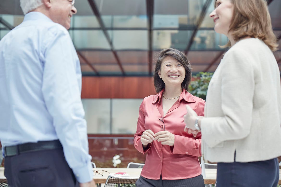 three-people-smiling-and-talking