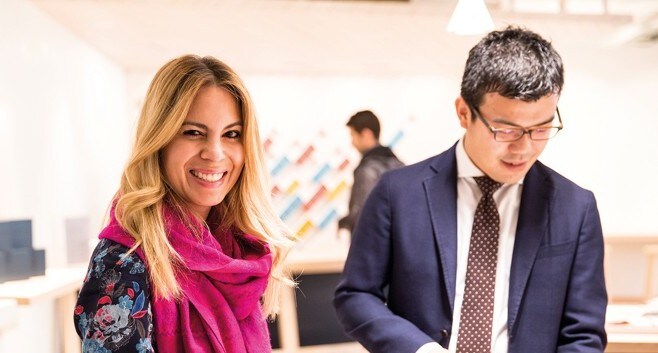Smiling person and colleague checking information