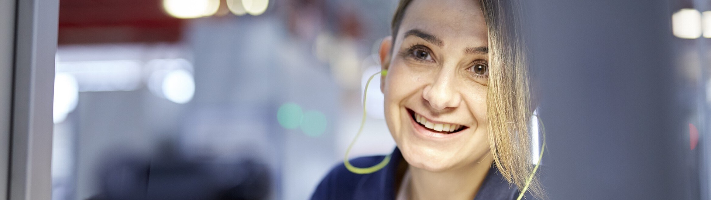 portrait of woman in factory smiling