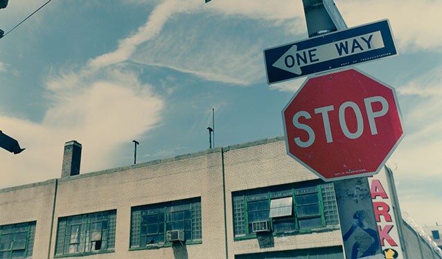 Stop and one way signs on a street in the U.S.