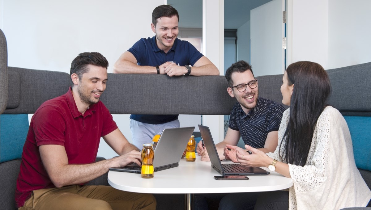 four-pmi-employees-sitting-meeting-booth